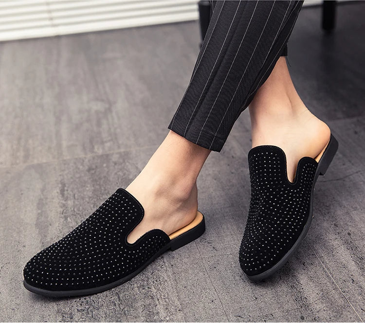 black mule loafers for men, worn by a gentleman